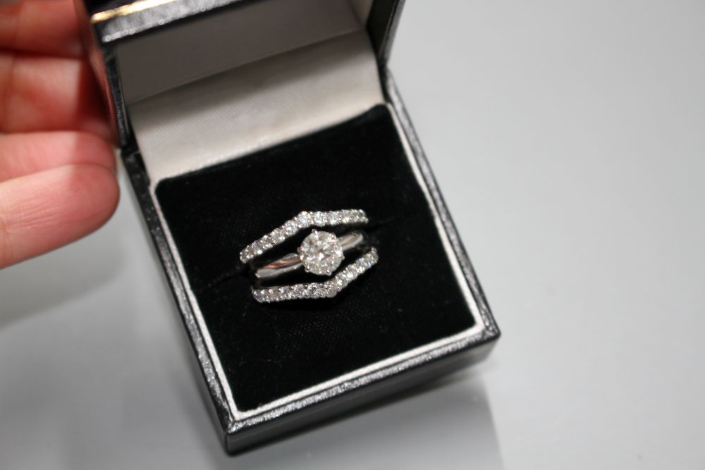 A modern 14kt white metal and triple band diamond dress ring,